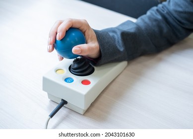 Woman With Cerebral Palsy Works On A Specialized Computer Mouse.