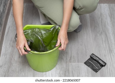 A Woman Changes A Garbage Bag In A Bucket. Man Tearing Off A Trash Bag. 