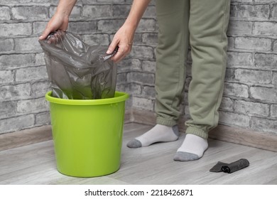 A Woman Changes A Garbage Bag In A Bucket. Woman Tearing Off A Trash Bag. High Quality Photo