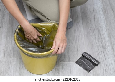 A Woman Changes A Garbage Bag In A Bucket. Woman Tearing Off A Trash Bag. 