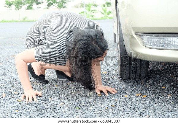 woman changing car\
wheel