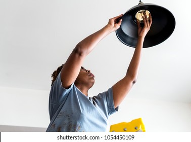 Woman Changing Lightbulb