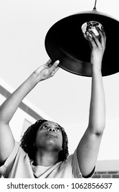 Woman Changing Lightbulb