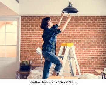 Woman Changing Lightbulb