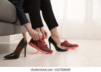 Woman changing shoes on sofa in office, closeup - Powered by Shutterstock