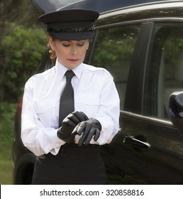 Woman Chauffeur Putting On Her Uniform Black Leather Gloves