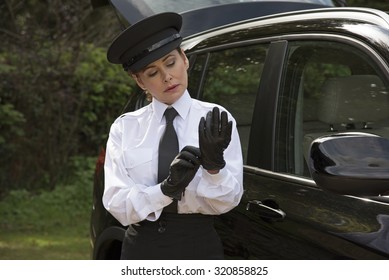 Woman Chauffeur Putting On Her Uniform Black Leather Gloves