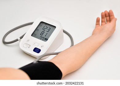 Woman Check Blood Pressure Monitor And Heart Rate Monitor With Digital Pressure Gauge. Healthcare And Medical Concepts