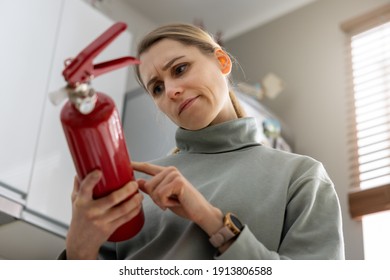 Woman Check The Fire Extinguisher Expiration Date At Home