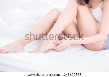 woman check her foot because of dry skin at home