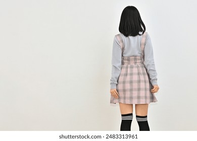 Woman in checked skirt with shoulder straps - Powered by Shutterstock
