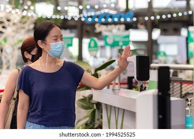 Woman Checking Body Temperature By Infrared Digital Thermometer With His Hand