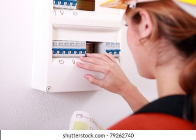 Woman Checking Electric Meter