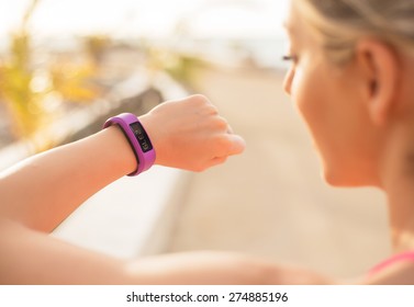 Woman checking fitness and health tracking wearable device