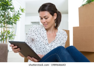 Woman Checking Her Account During Moving