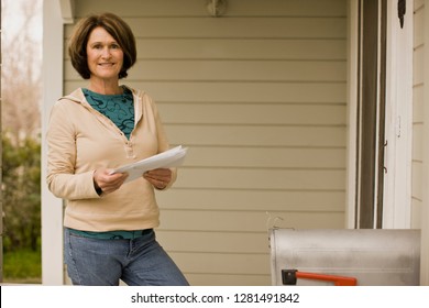 A Woman Checking Her Mailbox.