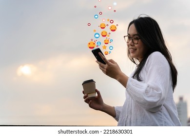 Woman checking her phone in front of big city skyline, using social media on mobile phone in the morning. copy space. focus on the hand holding the smartphone