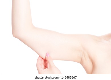 woman checking her upper arm, isolated on white background
