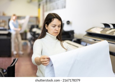 Woman Checking Large Format Paper After Printing. Press Worker Looking At Paper.