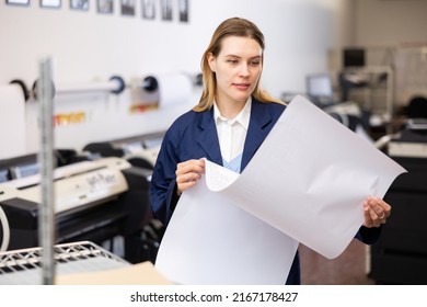 Woman Checking Large Format Paper After Printing. Press Worker Looking At Paper.