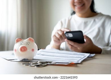 Woman Checking Money Save Interest And Profit On Mobile Phone. Online Banking Transaction Concept By Woman Use Smartphone App Access Bank Account Online For Bill Payment And Transaction Checklist.