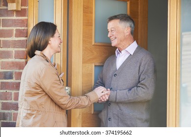 Woman Checking On Elderly Male Neighbor