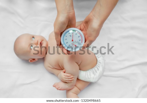 Woman Checking Temperature Humidity Baby Room Stock Photo