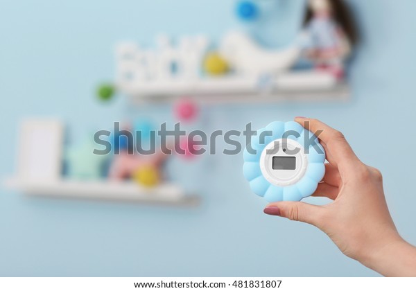 Woman Checking Temperature Humidity Baby Room Stock Photo