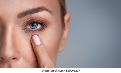 
Woman Checking Wrinkles Around The Eyes, Close Up 