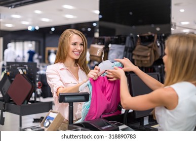 Woman At The Checkout Makes Shopping