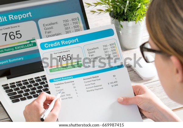 The woman checks the credit report and how many\
credit points.