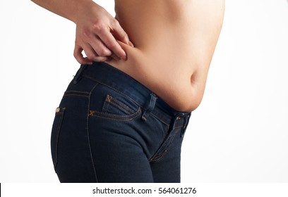 Woman checks and pinching Excess fat on her hip. Overweight concept
