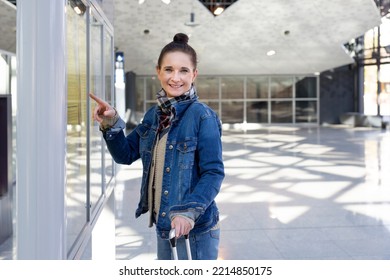 The Woman Checks The Train Timetable.