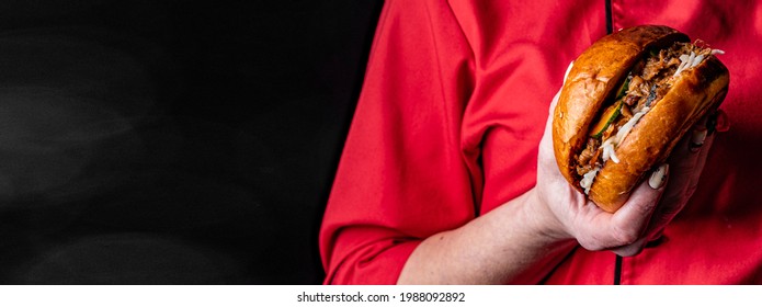 Woman Chef Holding Burger In Hand