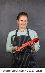 Woman Chef On A Dark Background. Mint Coat And Black Apron. Rhubarb