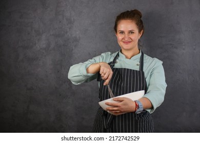 Woman Chef On A Dark Background. Mint Coat And Black Apron. Rhubarb