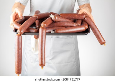 A Woman Chef Is Showing A Heap Of Homemade Turkish Sucuk Or Sausage On A Tray. Processed Fermented Spicy Red Meat Consumption Concept.