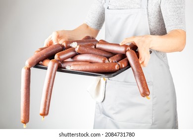 A Woman Chef Is Showing A Heap Of Homemade Turkish Sucuk Or Sausage On A Tray. Processed Fermented Spicy Red Meat Consumption Concept.