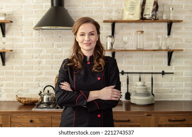 Woman in chef's uniform in the kitchen. Space for text. Professional pastry chef, chocolatier, baker or cook