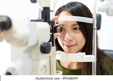 Woman Cheking Eye Test In Clinic