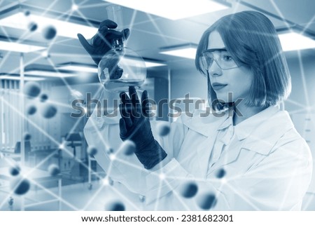 Woman chemist. Scientist with glass flask. Medical laboratory assistant. Chemist holds test tube. Woman scientist in white coat. Scientist conducts scientific experiment. Chemist at work