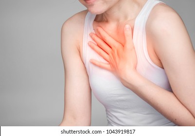 Woman With Chest Pain Or Nape. Concept Photo With Read Spot Indicating Location Of The Pain.