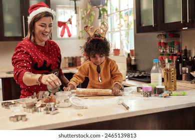 Woman, child and baking with christmas, love and dough learning for cookies in kitchen together. Smile, food and celebration with mother, adopted son and boy in home to prepare sweet treat or snack - Powered by Shutterstock