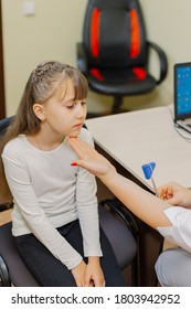 Woman Child Neurologist Examines The Girl In The Office.