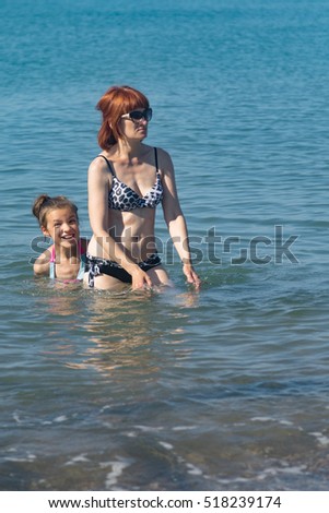 a woman with a child on the beach, sea, summer
