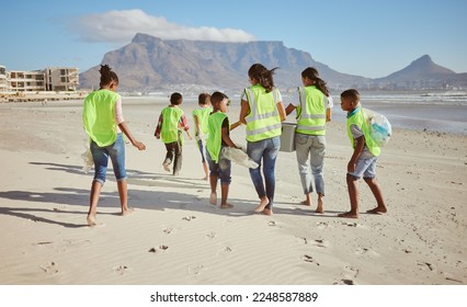 Woman, children and beach clean up in school accountability learning, climate change collection or sustainability recycling. Kids, students diversity and people in community service or ocean cleaning - Powered by Shutterstock