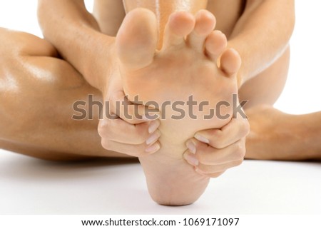 Woman in chiropody and body care massages her feet