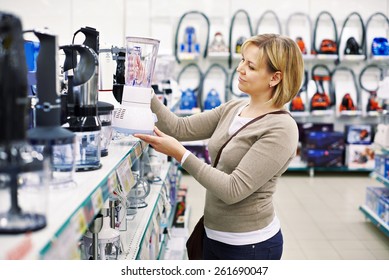 Woman Chooses A Blender In The Store