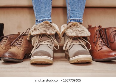 Woman chooses comfortable shoes among bunch of different pairs