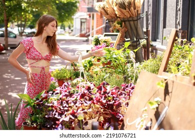 Woman Chooses Flowers In A Flower Shop Outside